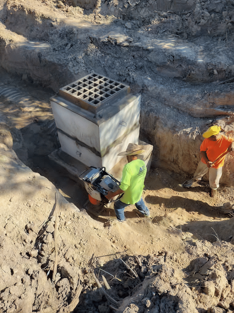 Crew clearing and inspecting a drainage structure in Montgomery County